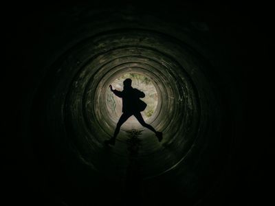 Silhouette of a person in a dynamic jumping motion.